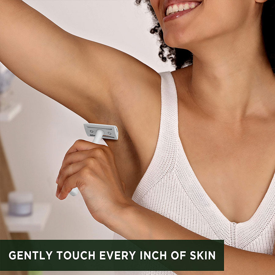 A Woman Is Shaving Her Armpits With A Zomchi White Safety Razor